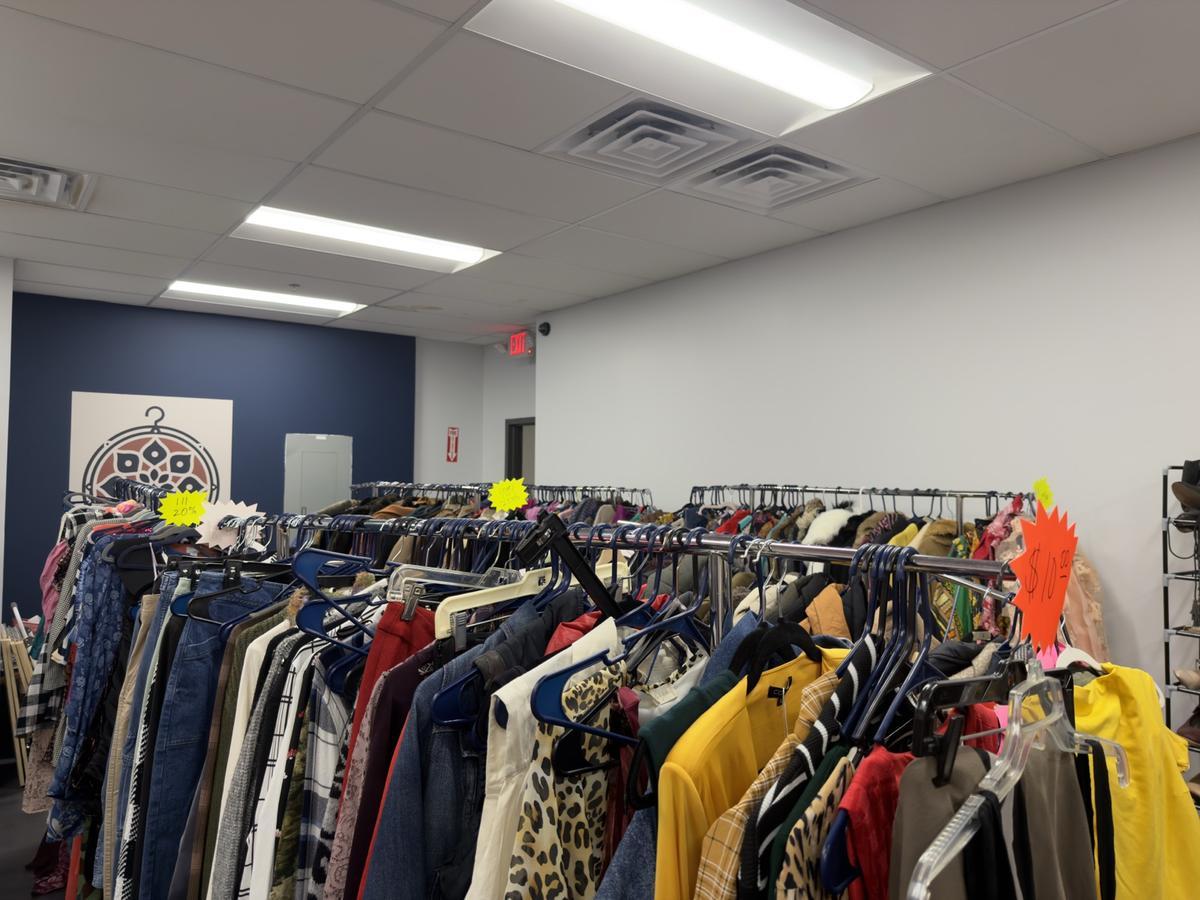 Wide interior view of clothing racks and vendor booths at Kinfolk Marketplace