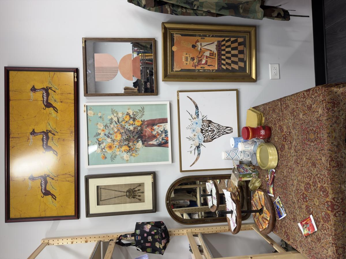 Gallery wall of framed art and decor inside a Kinfolk vendor booth