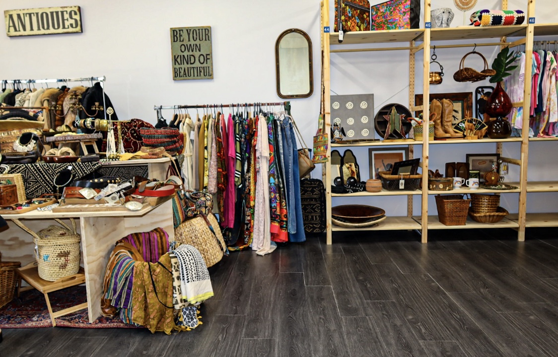 Wide view of the Kinfolk Marketplace shop floor showing antiques, clothing racks, and curated booth shelving